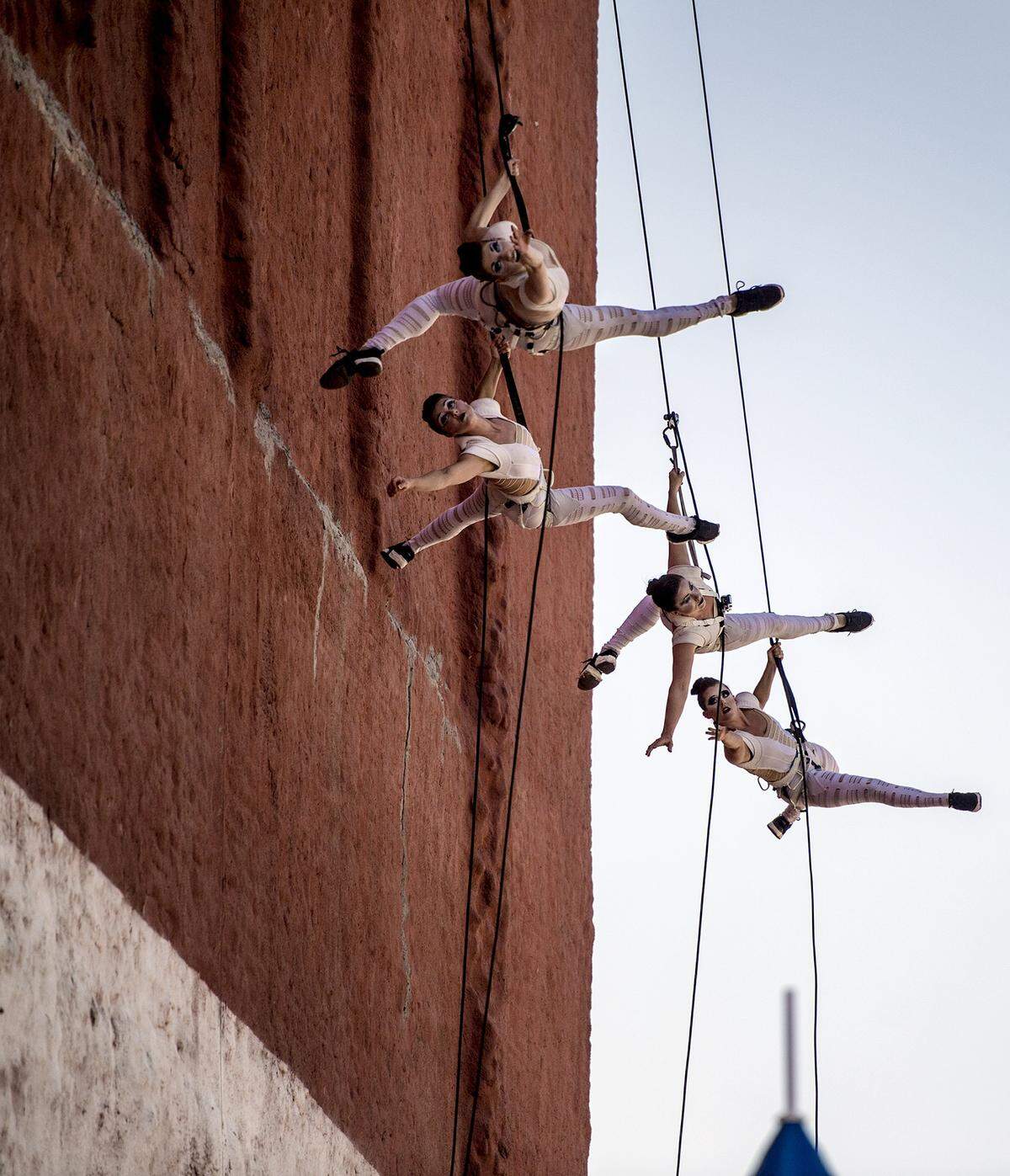 Members of Quixotic perform on the side of a building on Saturday, June 20, 2015, during Boulevardia in the West Bottoms.