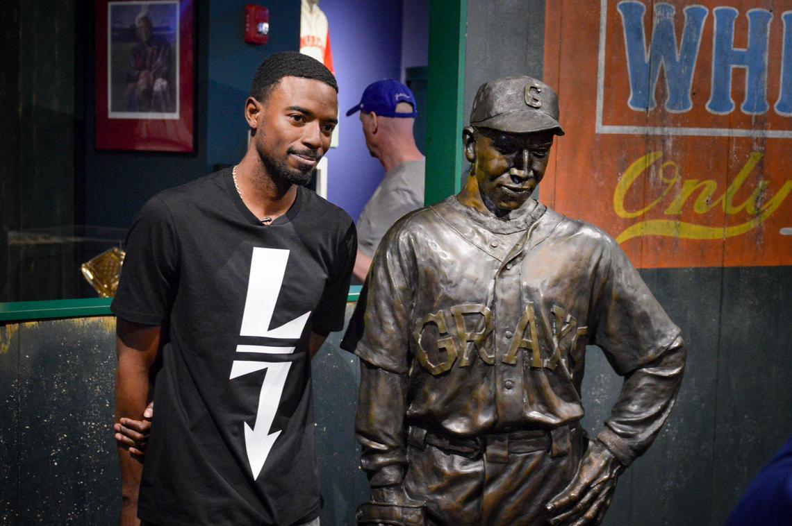 Seattle Mariners second baseman Dee Gordon with the statue of Cool Papa Bell. On day games, Gordon wears his pants legs pulled up to expose his socks because that’s the way Cool Papa Bell did it.