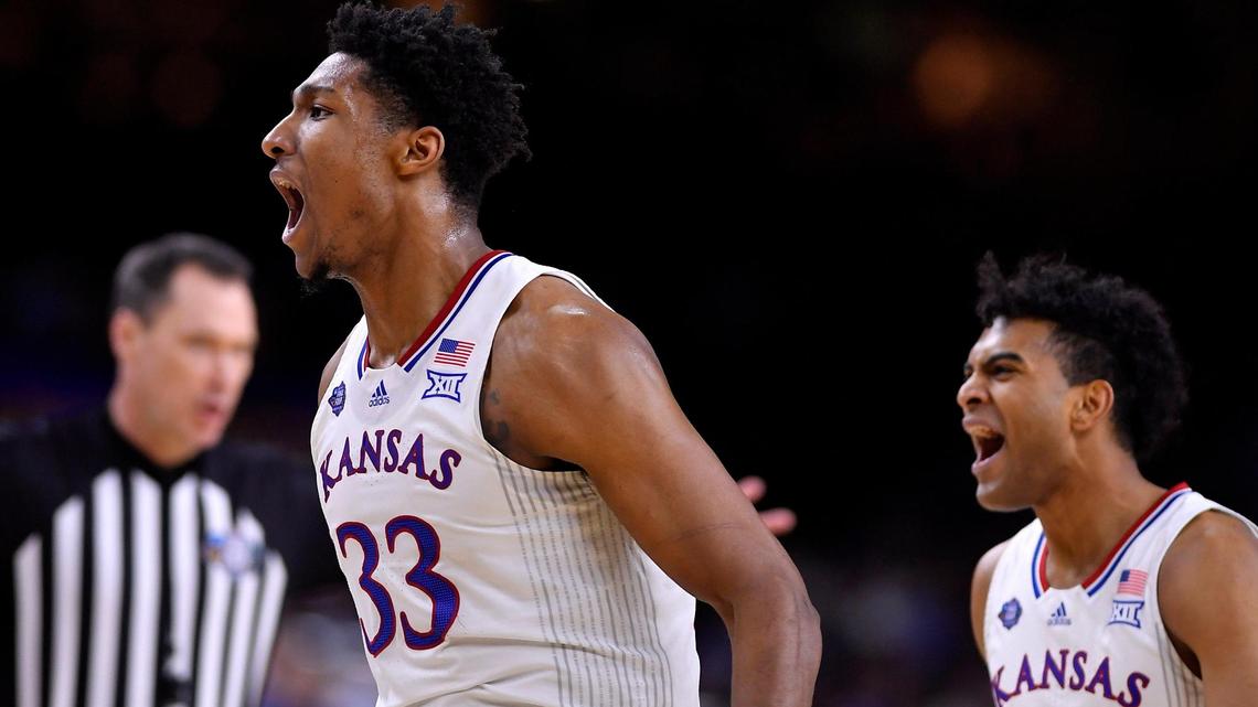 David McCormack, left, and the Jayhawks came out red out and he and guard Remy Martin expressed their happiness after Villanova called another timeout during the first half of Saturday’s NCAA national semifinal at the Final Four at the Superdome in New Orleans. KU beat Villanova, 81-65.
