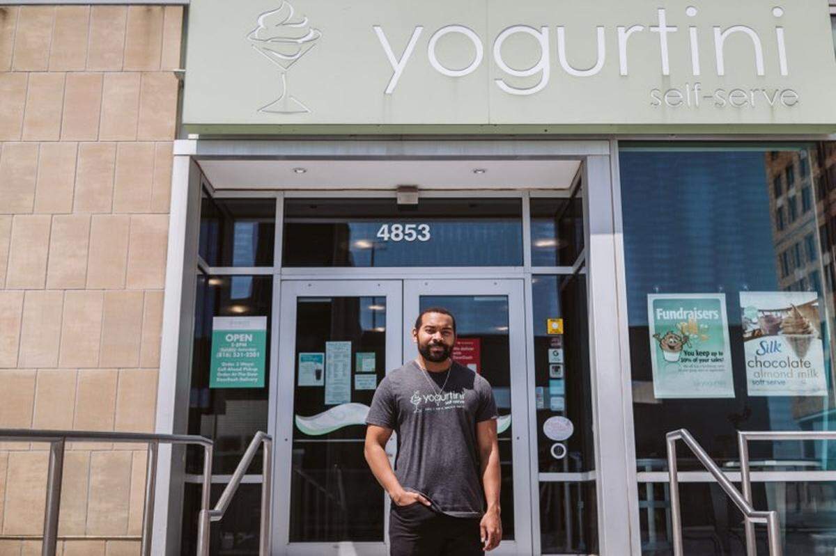Isaac Collins, owner of Yogurtini, passed out free frozen yogurt to protesters near the Country Club Plaza.