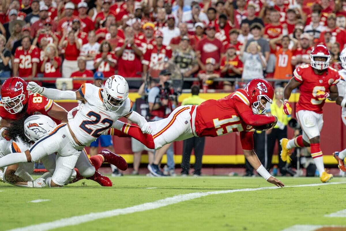 Kansas City Chiefs quarterback Patrick Mahomes (15) dives to make a touchdown in the first quarter during the season opener against the Denver Broncos at Arrowhead Stadium on Monday, Sept. 14, 2026, in Kansas City.