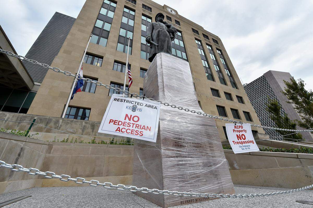 The statue in front of Kansas City Police headquarters was wrapped in plastic film and “no trespassing” signs were seen Wednesday, Sept. 23, 2020. Earlier, a grand jury decided not to charge any of the three Louisville police officers involved in the killing of Breonna Taylor.