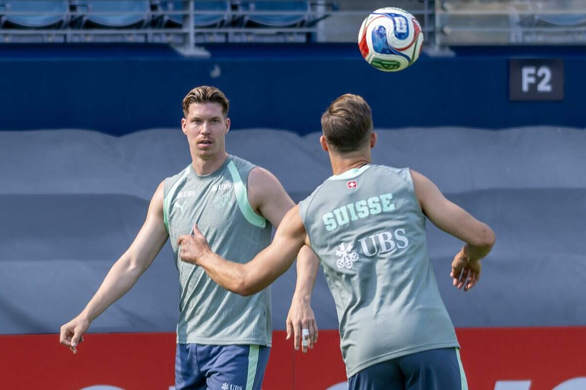 Members of the Switzerland national soccer team warm up by passing a ball in a circle before practice at Sporting Park on Thursday, July 9, 2026, in Kansas City, Kansas.