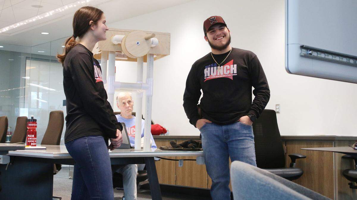Samantha Herron and Luis Montanez, seniors in the engineering program at Shawnee Mission’s Center for Academic Achievement, present their design for a lunar work table to their mentors at NASA via a video chat as teacher Greg Thiel observes.