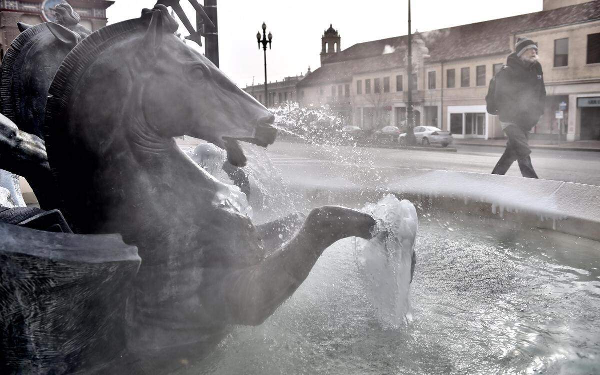Steam rises off the water flowing in the Neptune fountain on the Country Club Plaza.