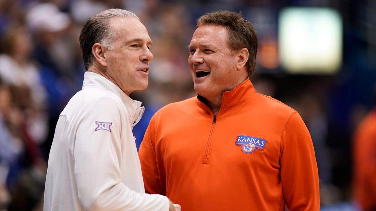 TCU coach Jamie Dixon, left, and Kansas coach Bill Self, right, have a laugh before tipoff of a game on Saturday, Jan. 21, 2023, at Allen Fieldhouse in Lawrence, Kan.