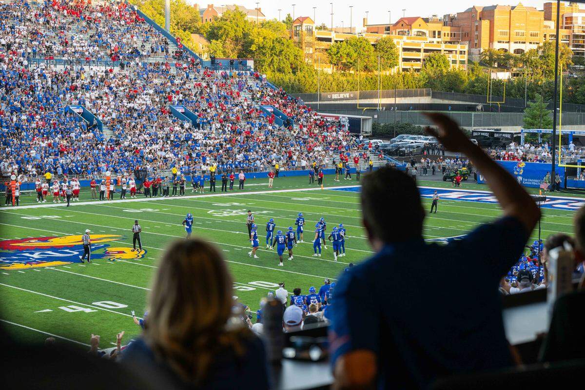 The crowd cheers underneath an awning inside the newly remodeled David Booth Kansas Memorial Stadium during the Jayhawks game vs. the Fresno State Bulldogs on Saturday, Aug. 23, 2025, in Lawrence.