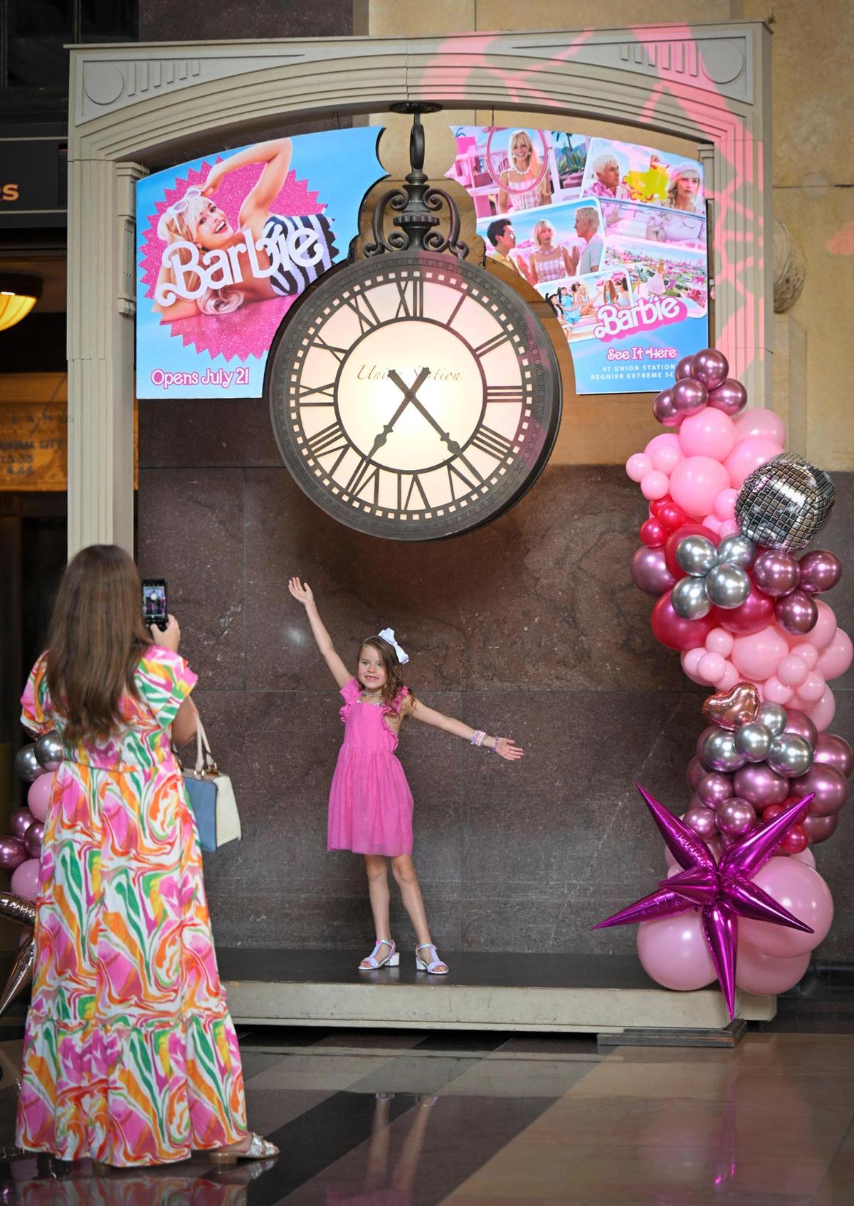 Opal Stevens of Merriam photographed her daughter, Pearl Stephens, 7, in a Barbie display during a visit to the Barbie-themed displays Thursday at Union Station.