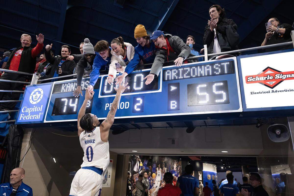 Kansas Jayhawks guard Shakeel Moore (0) greets fans after the team defeated the Arizona State Sun Devils, 74-55, at Allen Fieldhouse on Wednesday, Jan. 8, 2025, in Lawrence, Kansas. KU’s season ended later in the year with a first-round exit in the NCAA March Madness tournament.