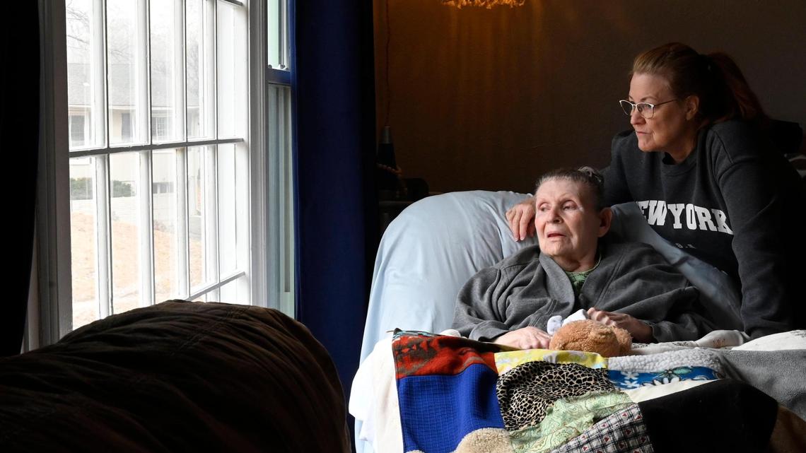 Ellen DeFoe, who is immobile and mostly non-verbal, enjoys looking out the big picture window from a recliner in Carol Dowell’s living room. Dowell is a full-time caregiver for DeFoe.