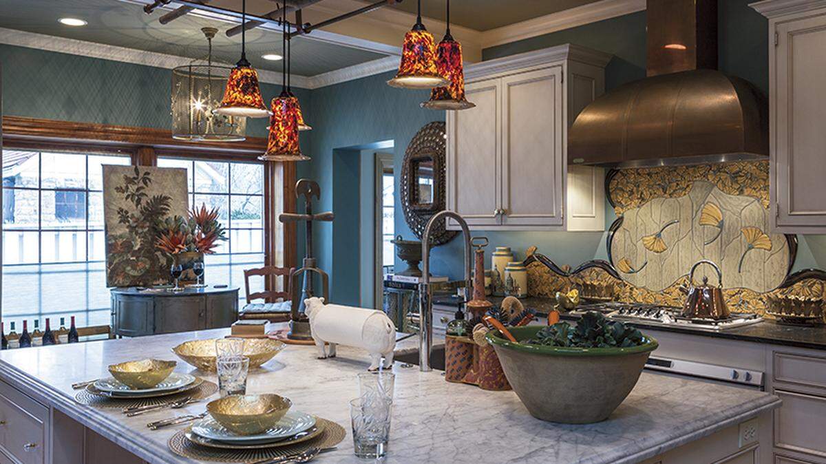 The 50th annual Symphony Designers’ Showhouse boasts a kitchen that was renovated by Kitchens by Kleweno in 2003 and 2013. It features a custom backsplash of swirling ginkgo leaves and a large copper ventilation hood.