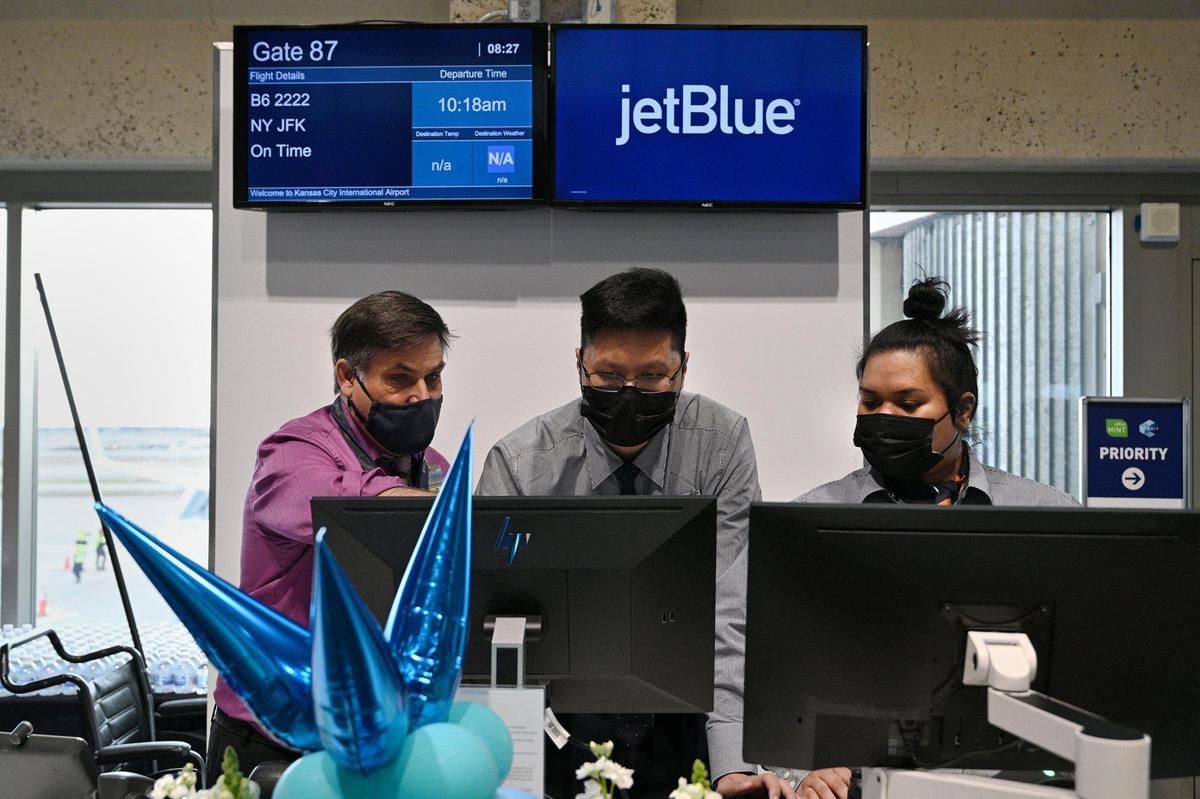 JetBlue supervisor Keith Mottola, from left, lends support to local crew members Tony Mai and Levene Kilafwakun as they prepare the gates. JetBlue’s inaugural flight from Kansas City International Airport left for New York’s John F. Kennedy International Airport Sunday morning, March 27, 2022. According to the Kansas City Aviation Department, area travelers have requested JetBlue for some time. In April 2021, the airline announced it will offer nonstop service to JFK and Boston Logan International Airport.