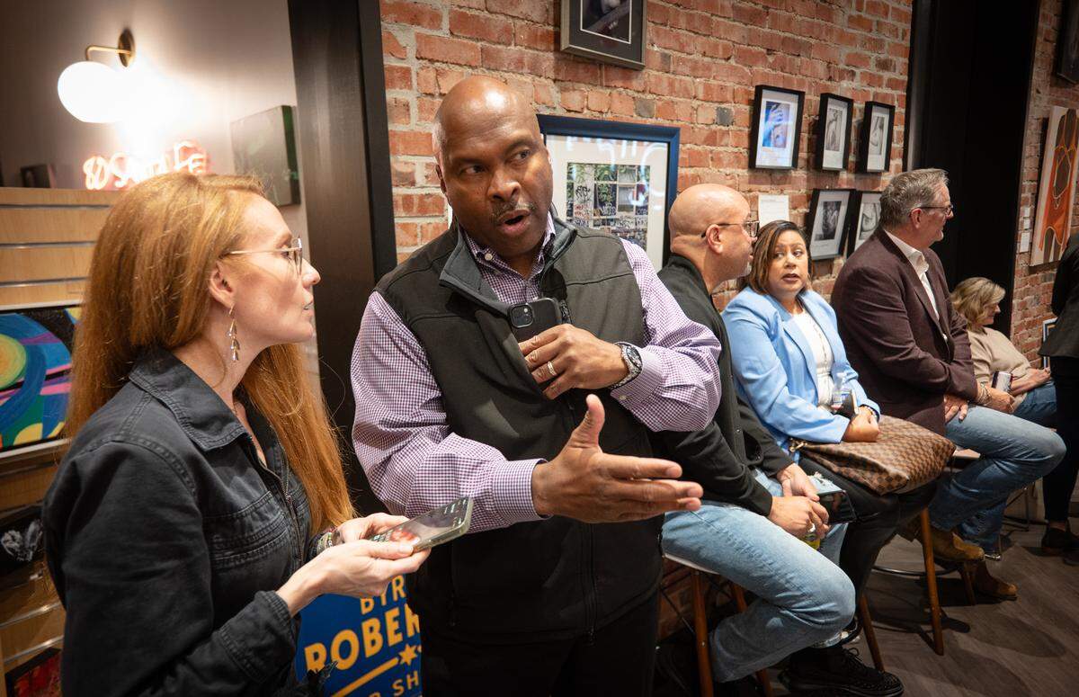 Johnson County Sheriff Byron Roberson talks to campaign assistant Jennifer Winfrey at an election night watch party on Tuesday, Nov. 5, 2024, in downtown Overland Park.