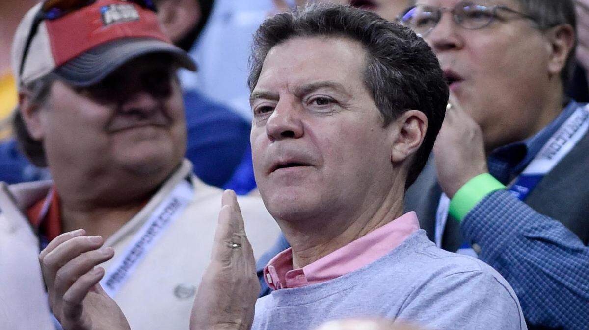 Kansas Gov. Sam Brownback applauded during player introductions during Sunday's NCAA Tounament game in Omaha. WSU won, 78-65.
