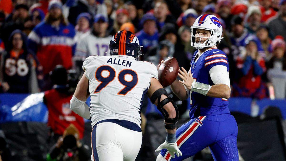 Buffalo Bills quarterback Josh Allen (17) looks downfield as he is pressured by Denver Broncos defensive end Zach Allen (99). Allen threw for 177 yards and a touchdown with two interceptions. He lost a fumble and also ran for a touchdown but the Bills lost to the Denver 24-22.