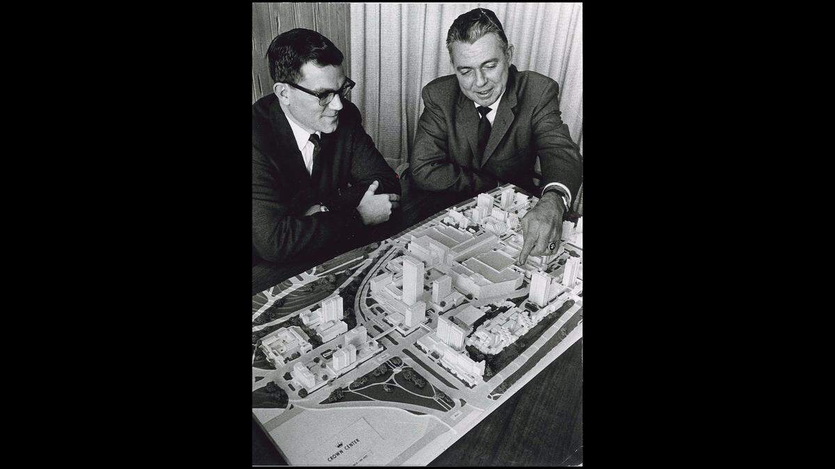 Donald J. Hall, left, then president and chief executive officer of Hallmark, and Lynn Bauer, president of Crown Center, look over a model of the planned Crown Center complex before it was completed in the early 1970s.