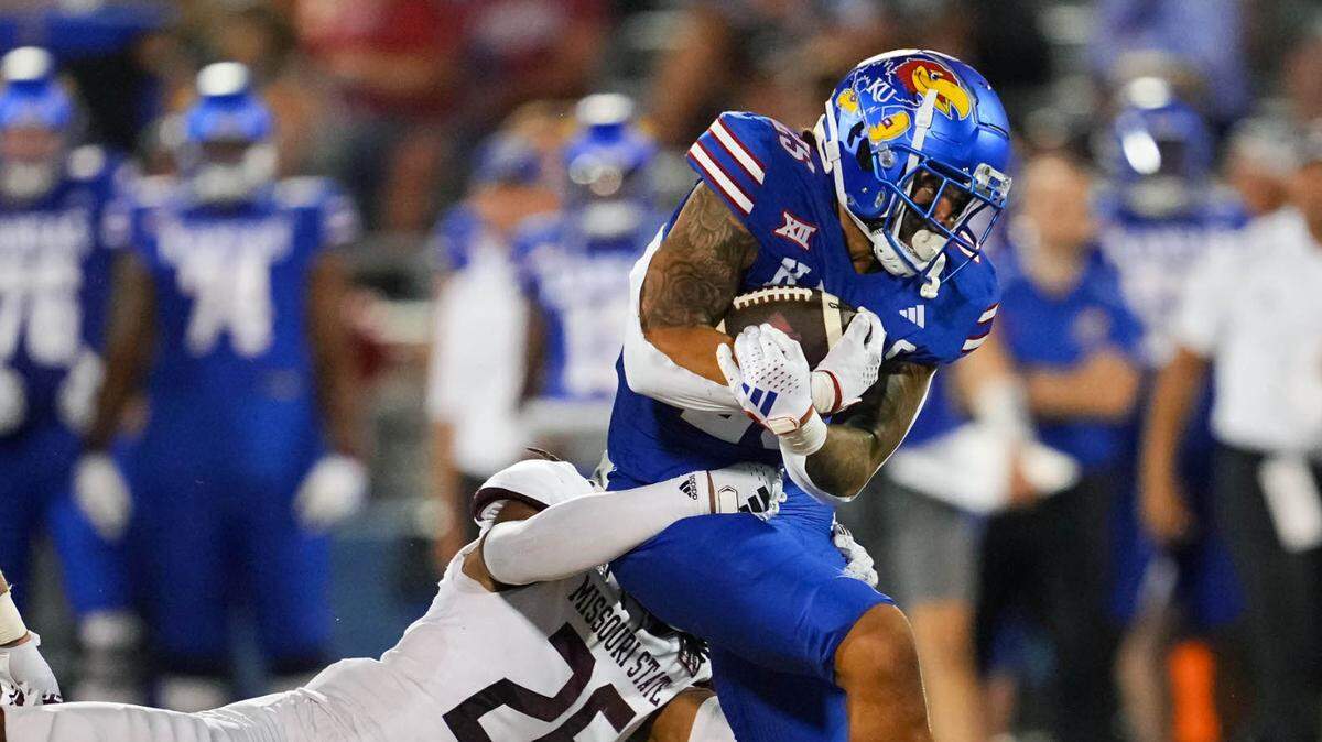 Kansas Jayhawks running back Dylan McDuffie (25) is tackled by Missouri State Bears linebacker Tahj Chambers (26) during the second half at David Booth Kansas Memorial Stadium on Sept. 1, 2023.