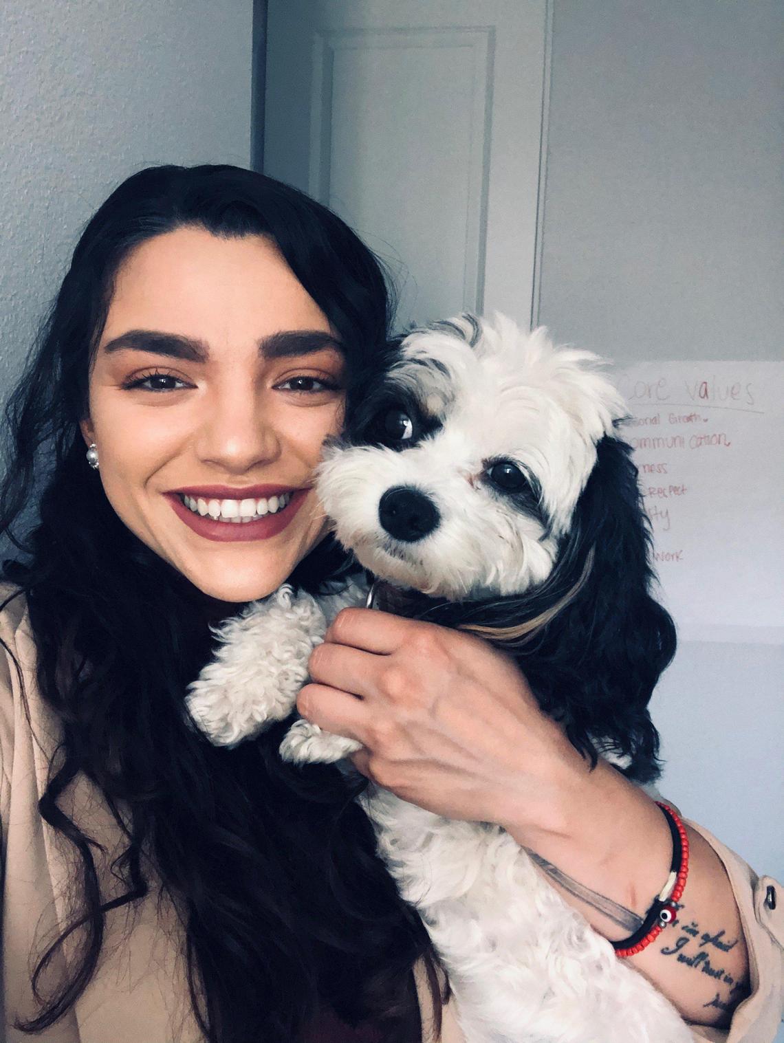 Genesis Osuna, with her emotional support dog Monito.