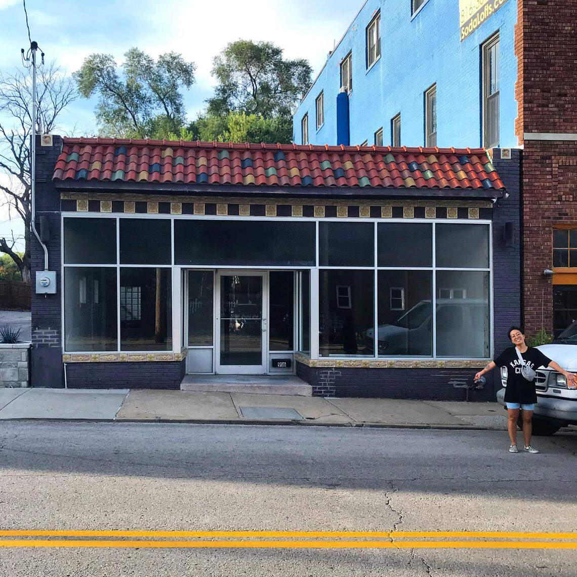 Cafe Cà Phê, a Vietnamese coffee truck, plans to open a storefront this winter at 916 East 5th Street in Kansas City’s Columbus Park neighborhood. Owner Jackie Nguyen is seen standing next to the new building.