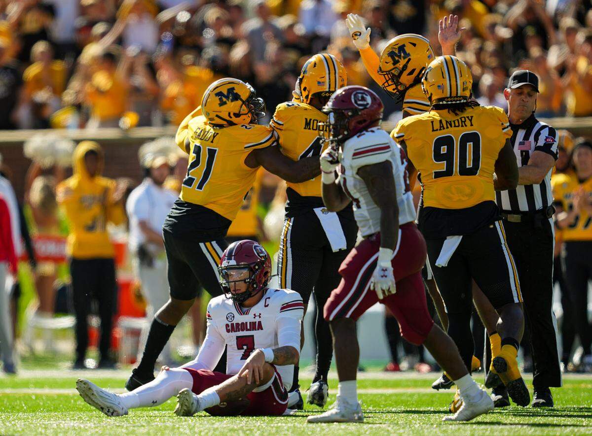 The Mizzou defense celebrates a sack of South Carolina Gamecocks quarterback Spencer Rattler during Saturday’s homecoming game at Faurot Field in Columbia.