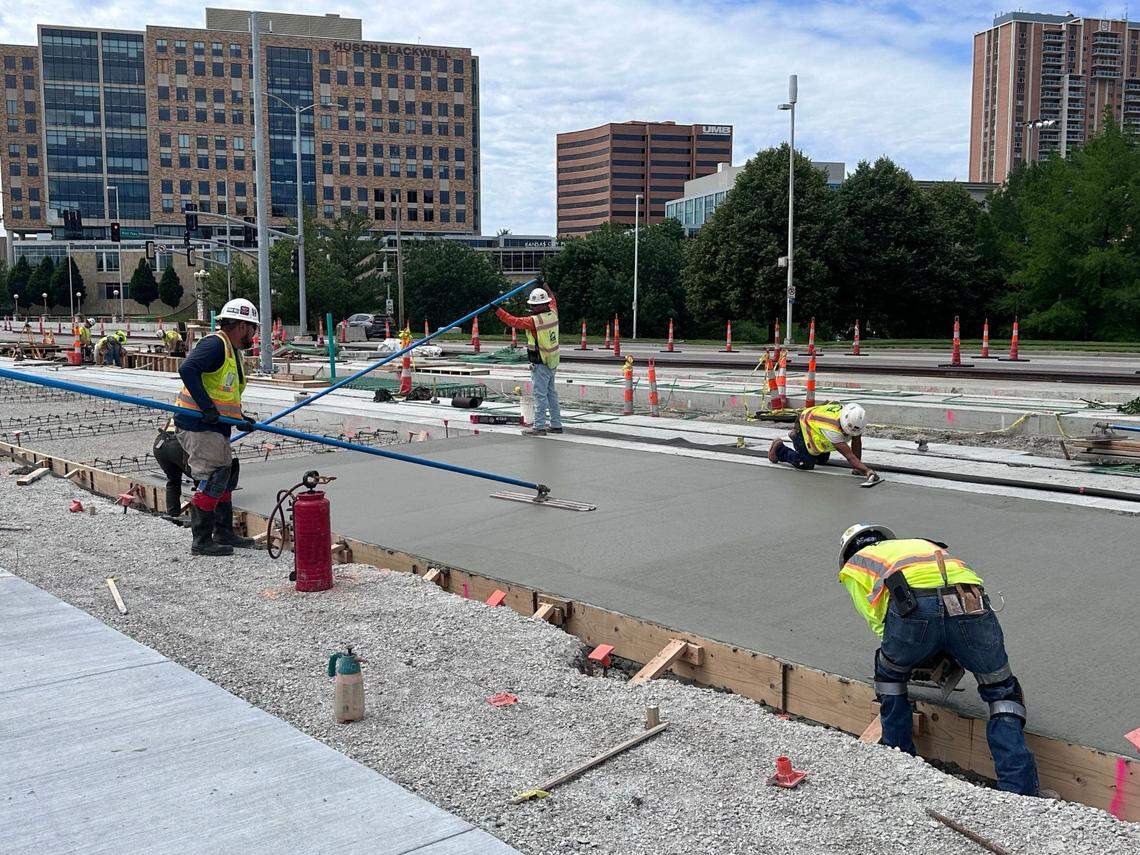 Workers smooth cement near the site of the forthcoming streetcar stop near the Country Club Plaza in Kansas City. Major construction for the streetcar’s southern extension is expected to wrap up by the end of 2024.
