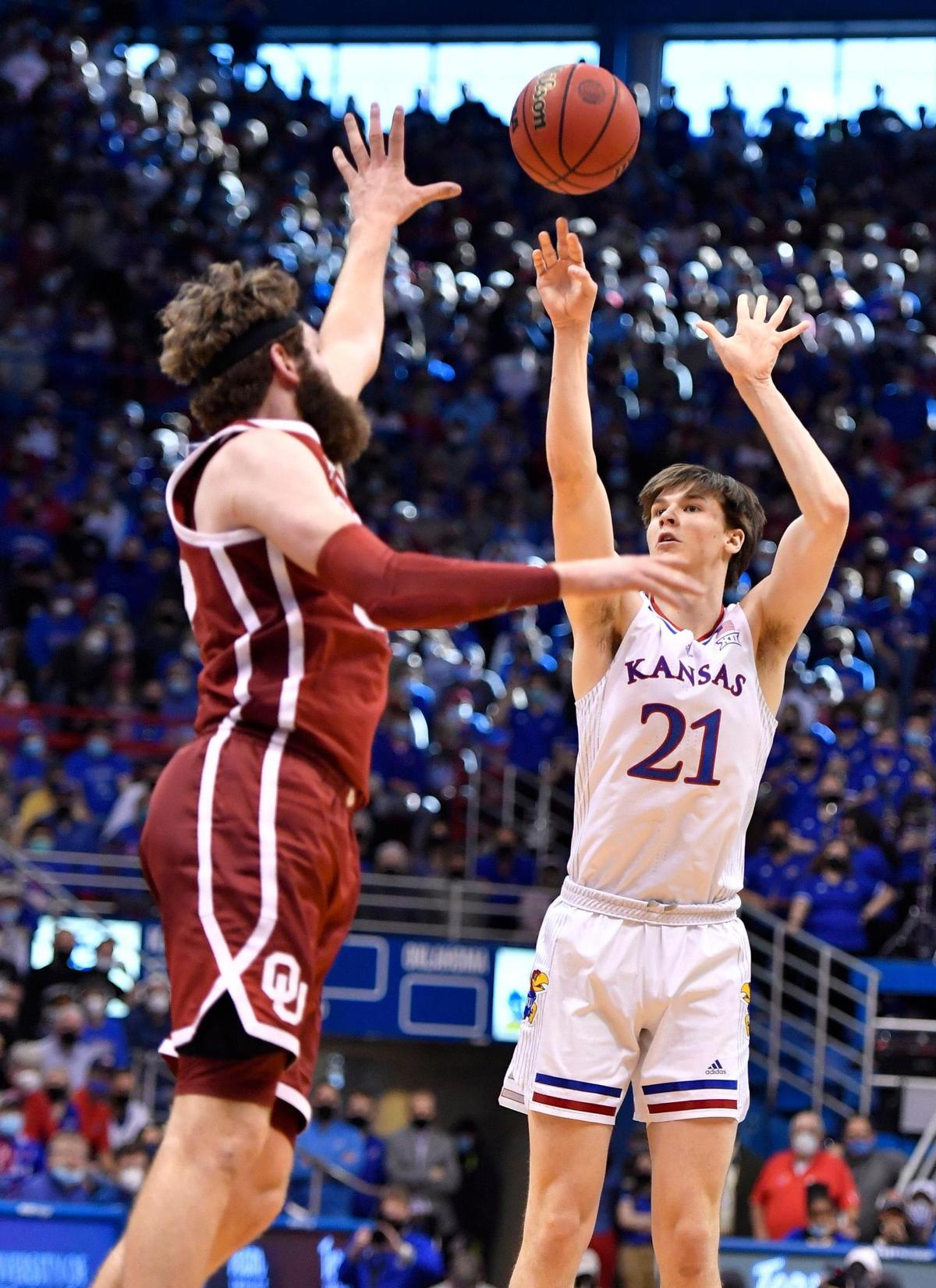 KU’s Zach Clemence hit a huge three-pointer over OU’s Tanner Groves during the second half of Saturday’s Big 12 Conference game at Allen Fieldhouse. KU beat OU, 71-69.