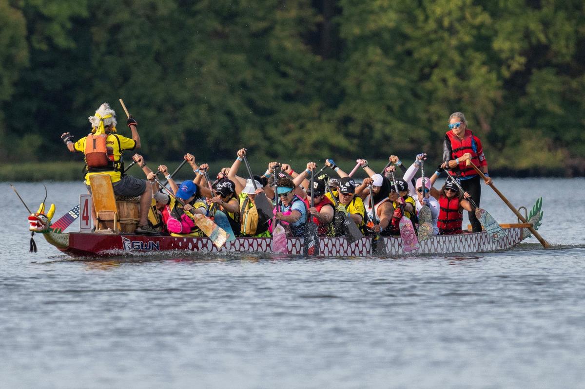 Crew members from Phantom Dragons paddle in a qualifying race during the KC Dragon Boat Festival on Saturday, Sept. 28, 2024, at Shawnee Mission Park.