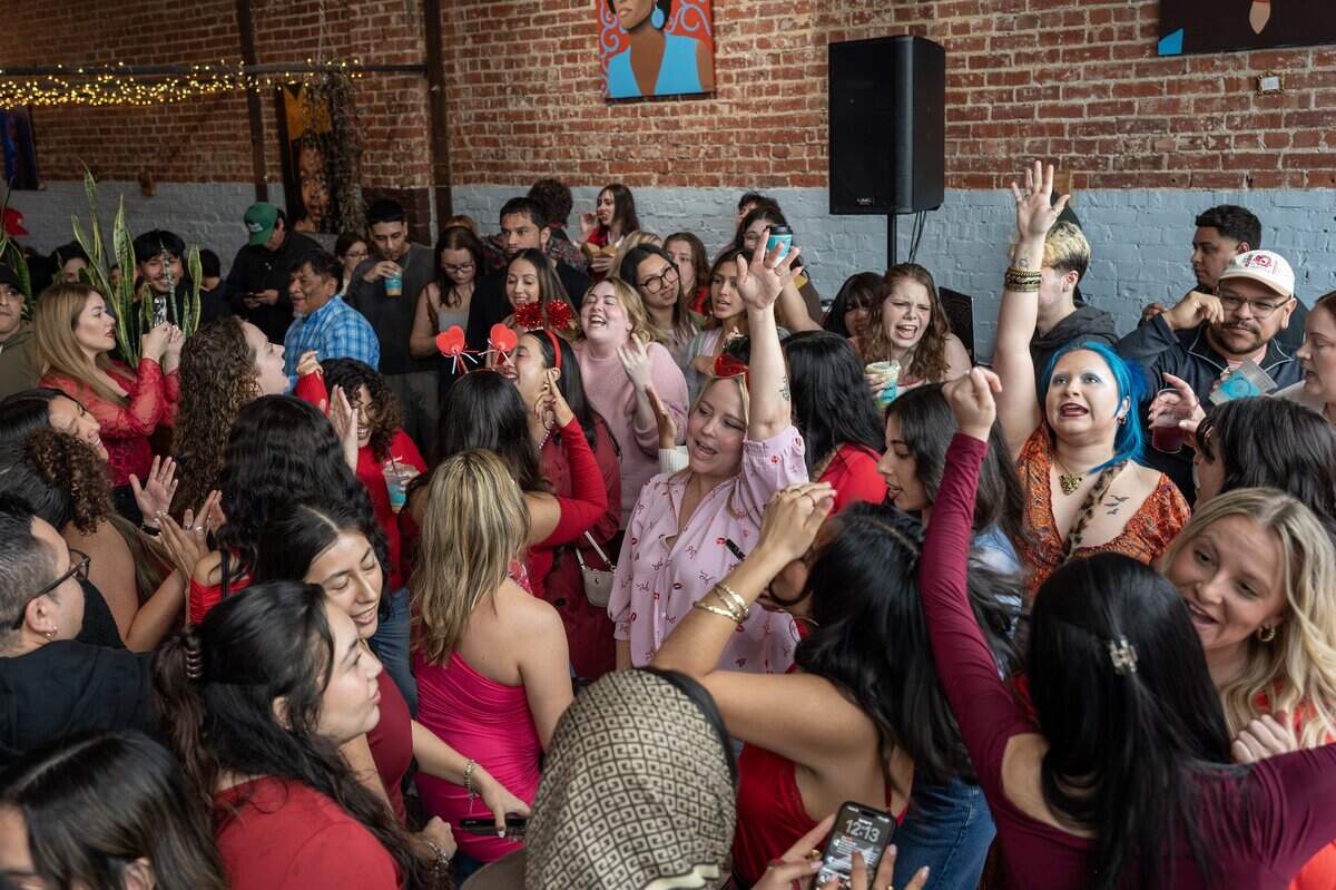 Attendees dance during the Bad Bunny look-alike contest at Café Corazón on Saturday, Feb. 14, 2026, in Kansas City.