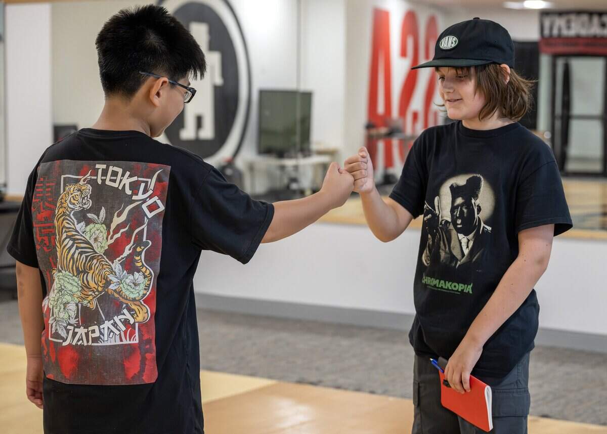 Hunter Nguyen, left, and Finley Walsh fist bump after Street Stylez Academy rehearsal at Hy-Vee Arena on Tuesday, Aug. 12, 2025, in Kansas City.
