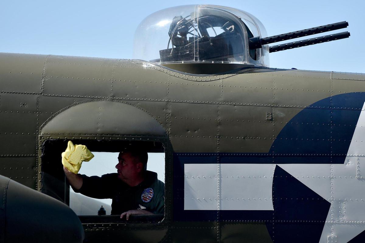 Tim Peterson, a member of the B-25 flight crew with the Yankee Air Museum in Belleville, Michigan, cleans a window of Rosie’s Reply, a B-25D bomber built at the North American Aviation plant in Fairfax. The plane arrived at Charles B. Wheeler Downtown Airport Monday, Oct. 4, 2021, the first time it has been back to Kansas City since it flew out for World War II. Rosie’s Replay is scheduled to fly over the Fairfax Festival Oct. 7.