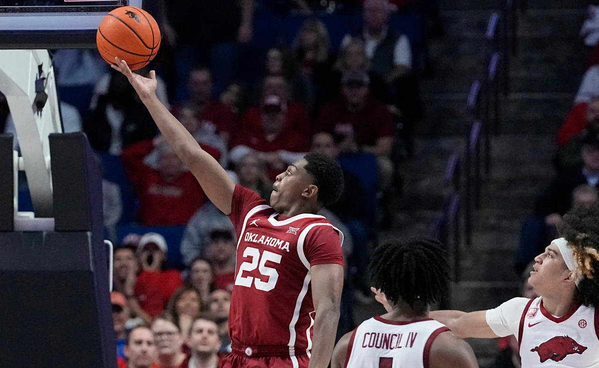 Oklahoma guard Grant Sherfield (25) shoots in front of Arkansas players in the second half on Saturday, Dec. 10, 2022, in Tulsa, Okla.