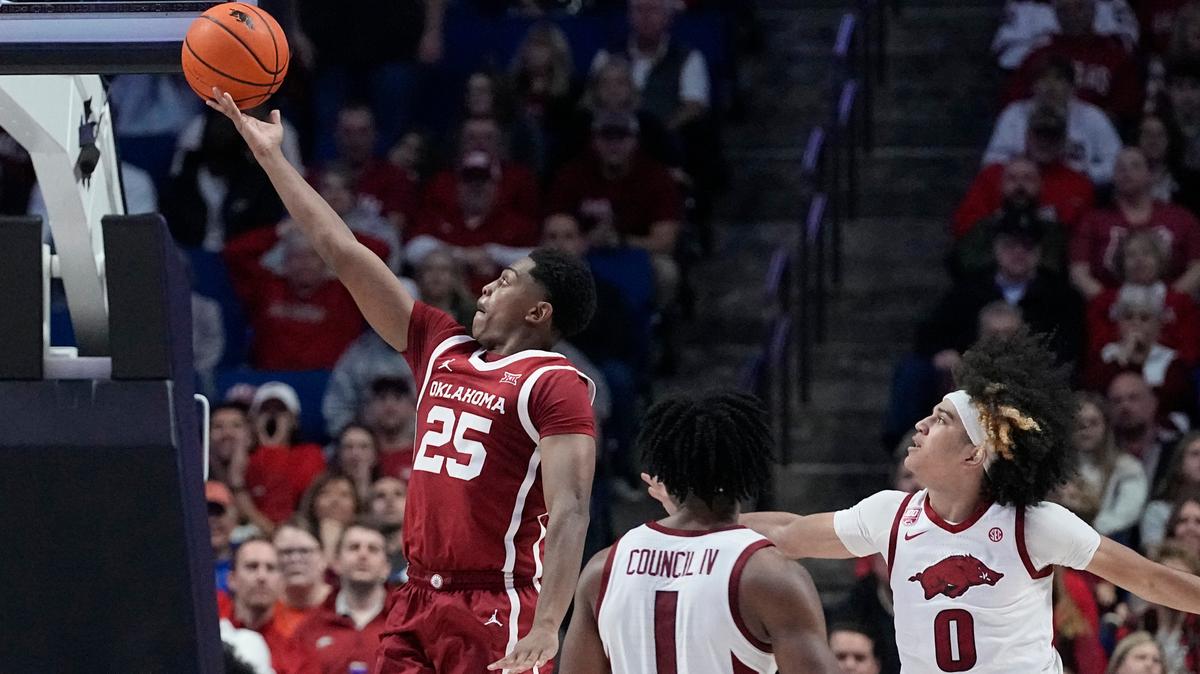 Oklahoma guard Grant Sherfield (25) shoots in front of Arkansas players in the second half on Saturday, Dec. 10, 2022, in Tulsa, Okla.