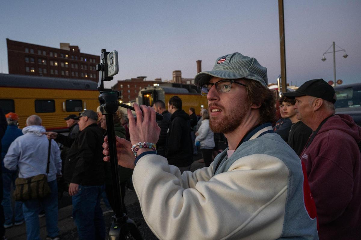 Nick Jungen of Springfield, Missouri, sets up his tripod to grab a photo of Union Pacific’s Big Boy as it rolled into Kansas City on Tuesday, Oct. 15, 2024. Jungen, a train enthusiast has a YouTube channel dedicated to trains.