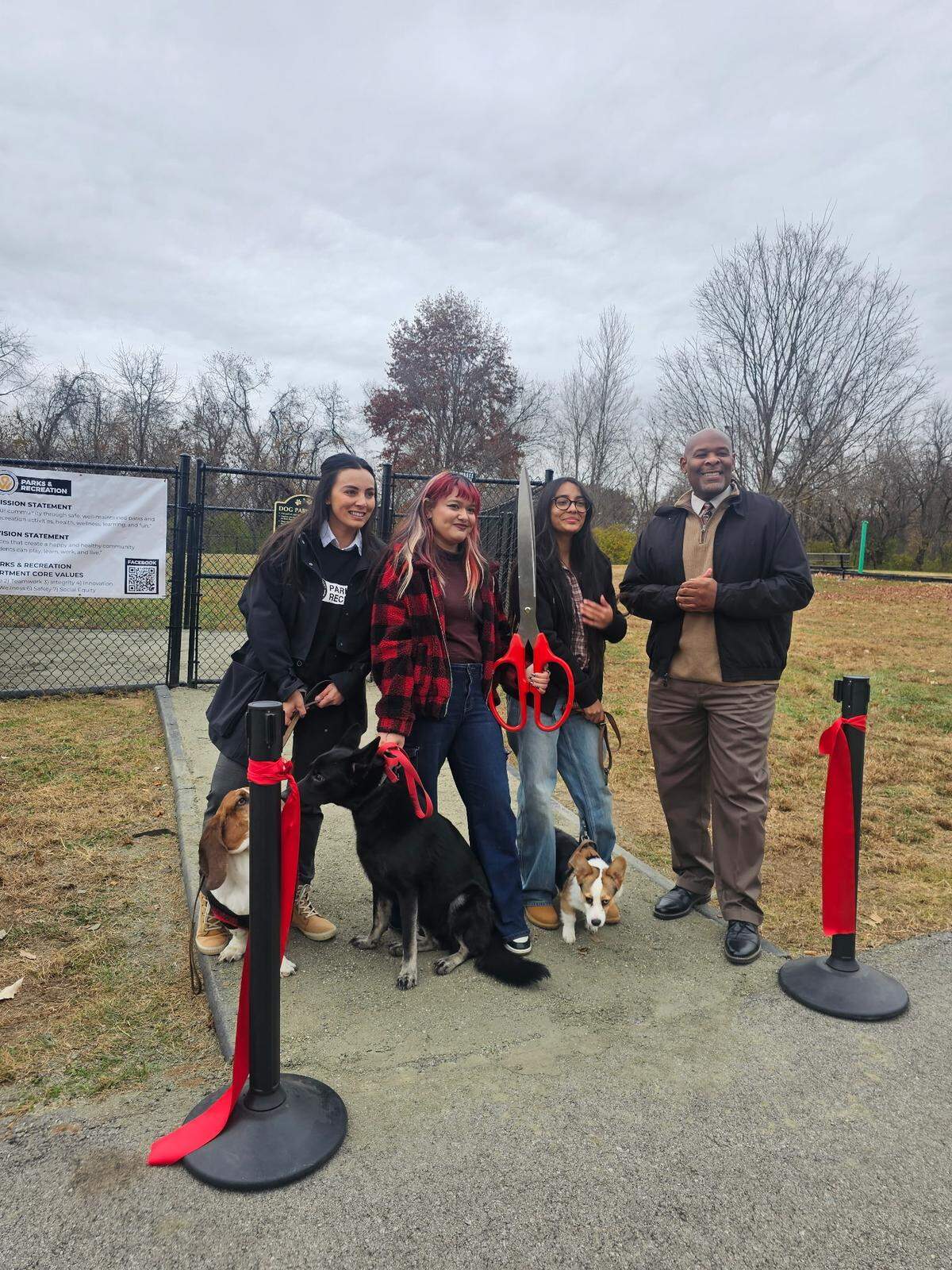 Samantha Osorio and Maritza Hernandez, center, stand for a portrait with Angel Ferrera, director of parks and recreation, and Mayor Tyrone Garner during the ribbon cutting for Welborn Dog Park on Nov. 17, 2025. Their pups tagged along for the celebrations.