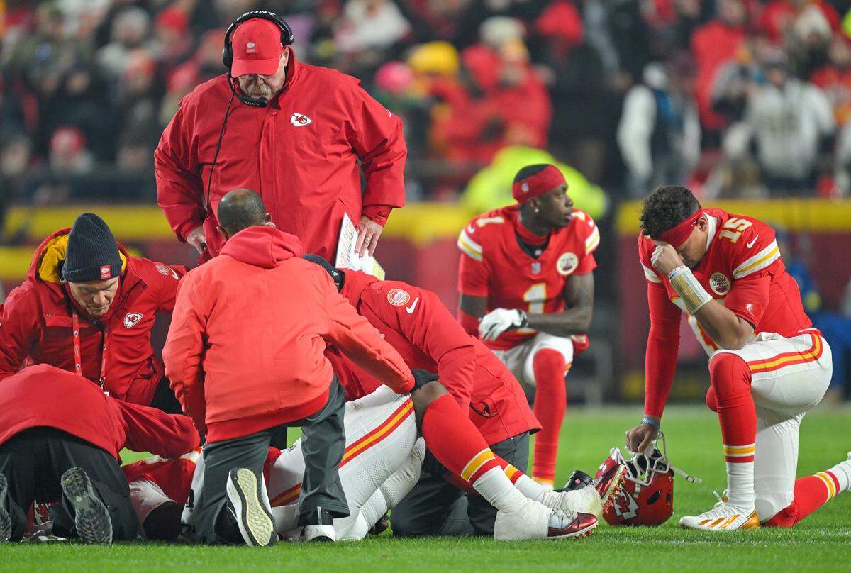 Trainers, staff and players gather around Kansas City Chiefs offensive tackle Wanya Morris (64) after he was injured in the first play against the Houston Texans at GEHA Field at Arrowhead Stadium on Sunday, Dec. 7, 2025.