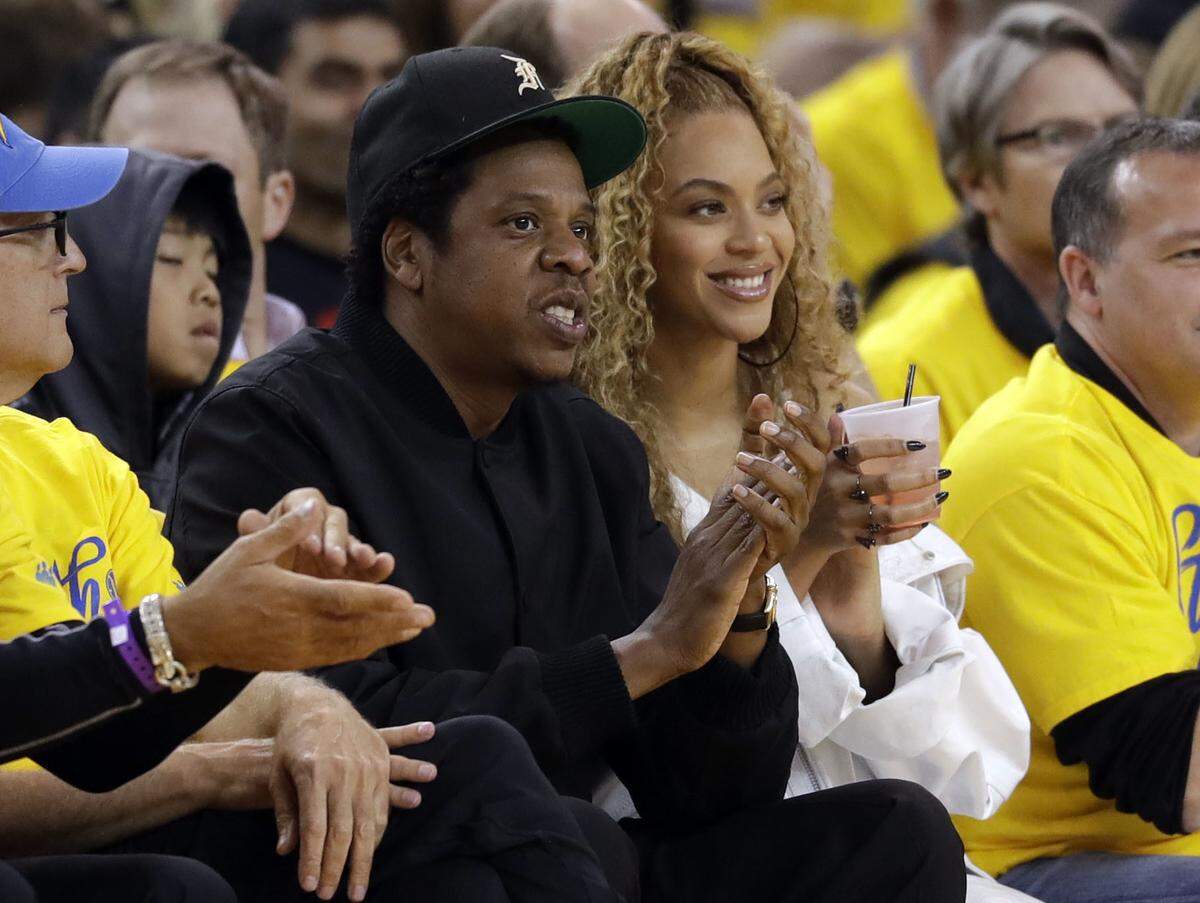 Jay-Z and Beyonce watch Game 1 of an NBA basketball second-round playoff series between the Golden State Warriors and the New Orleans Pelicans Saturday, April 28, 2018, in Oakland, Calif. (AP Photo/Marcio Jose Sanchez)