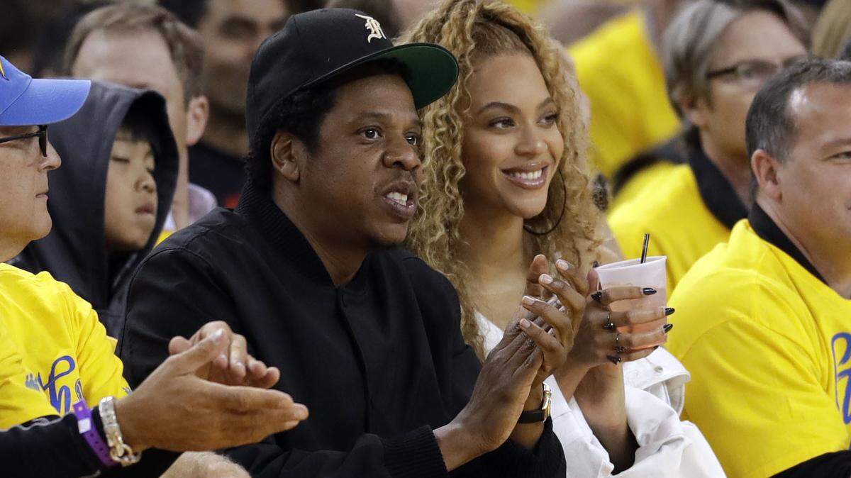 Jay-Z and Beyonce watch Game 1 of an NBA basketball second-round playoff series between the Golden State Warriors and the New Orleans Pelicans April 28, 2018. The couple is enticing fans to go vegan with concert tickets “for life.”
