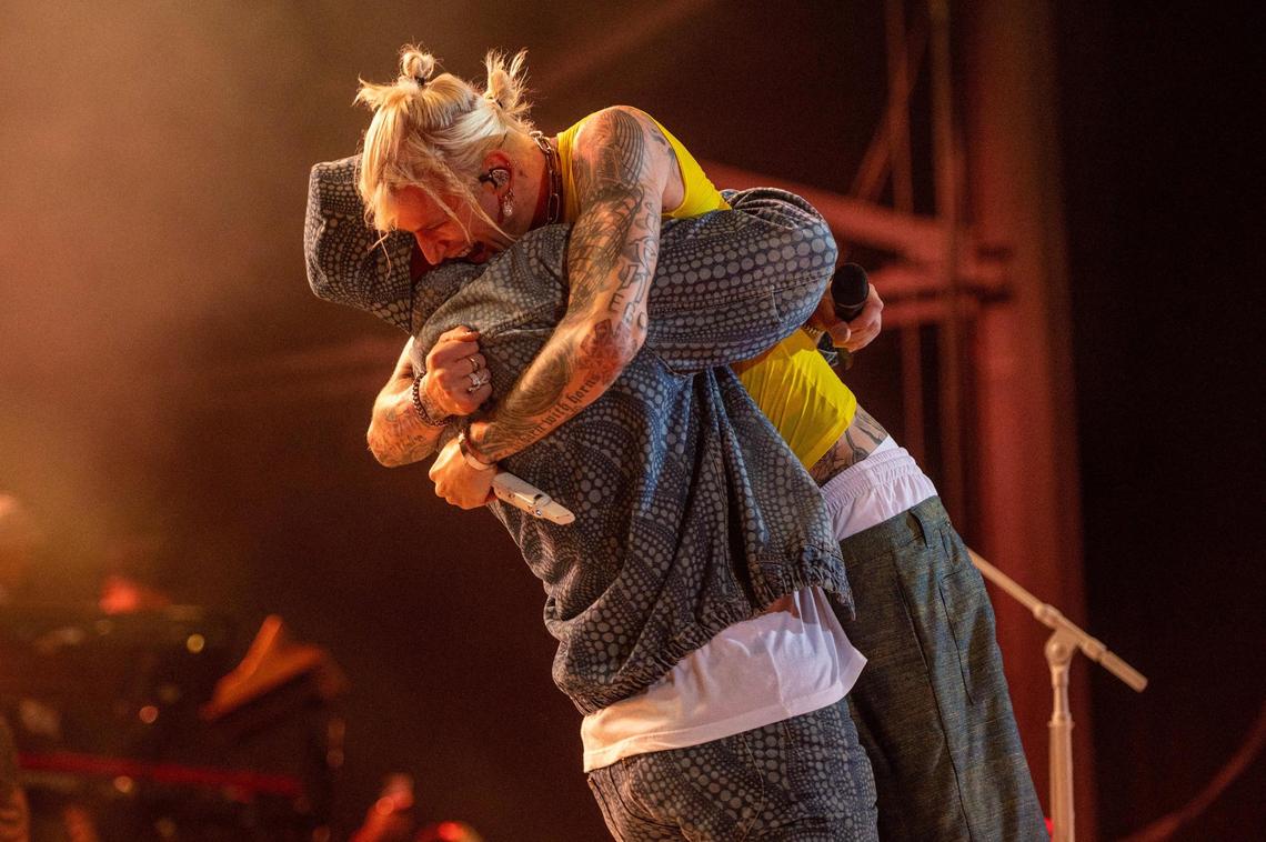 Travis Kelce, left, gives Machine Gun Kelly a hug while prerforming the Beastie Boys, “Fight For Your Right,” at Kelce Jam at the Azura Amphitheater on Friday, April 28, 2023, in Bonner Springs.