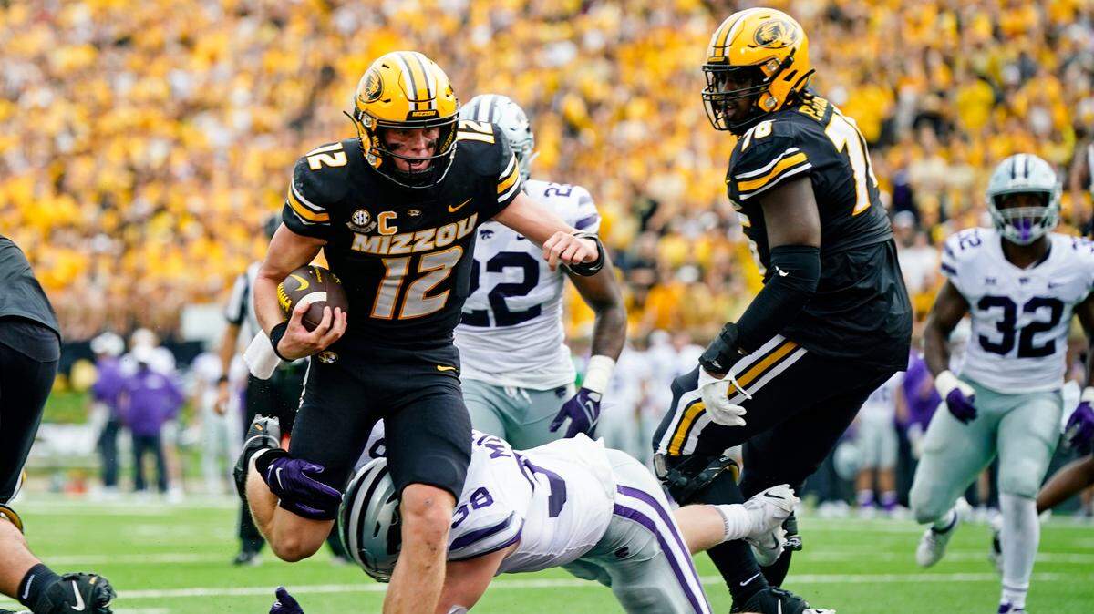 Missouri Tigers quarterback Brady Cook (12) scores a touchdown against Kansas State Wildcats defensive end Brendan Mott (38) during the first half at Faurot Field at Memorial Stadium on Sept. 16, 2023.