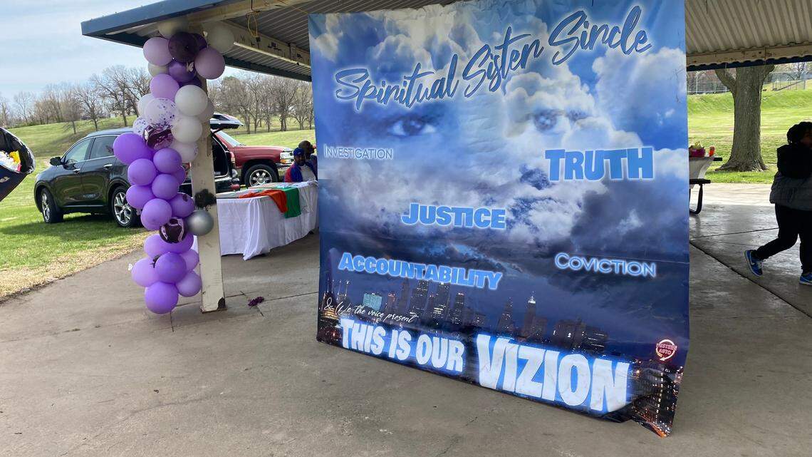 A banner hangs Saturday in Klamm Park in Kansas City, Kansas. About two dozen people showed up to honor and support families whose family members have been killed.