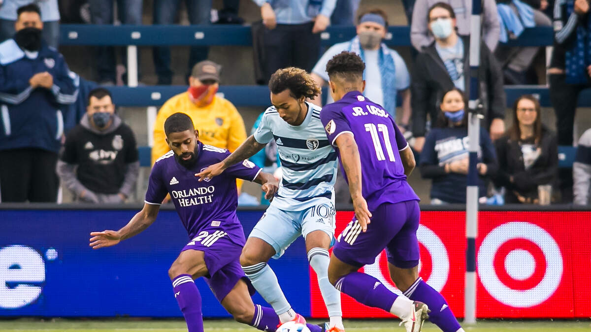 Sporting Kansas City’s Gianluca Busio shields of a pair of Orlando defenders in the home opener on Friday, April 23, 2021, at Children’s Mercy Park in Kansas City, Kansas.