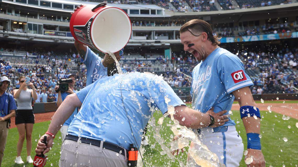 Kansas City Royals catcher Salvador Perez (13) and shortstop Bobby Witt Jr. (7) react as they splash Royals broadcaster Joel Goldberg after the game against the Cleveland Guardians at Kauffman Stadium on June 30, 2024.