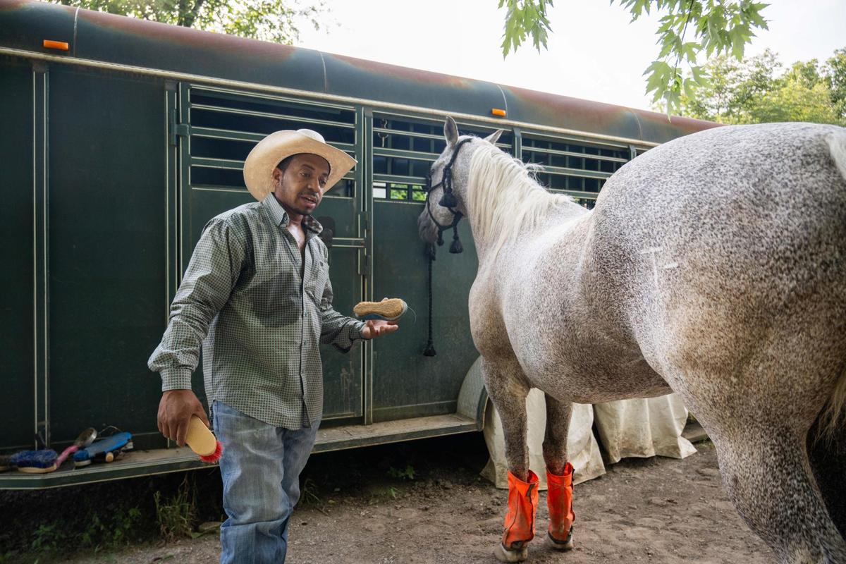 Daniel Bey brushes the hide of his horse, Fetty Wap, at his uncle’s ranch in Kansas City, Kansas on Wednesday, July 16, 2025. Bey will be participating in the Black Rodeo USA stop in Kansas City on July 26th at the American Royal Center.