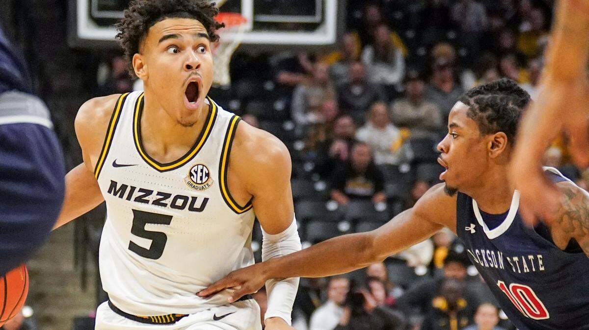 Missouri Tigers guard John Tonje, left, dribbles the ball upcourt as Jackson State’s Chase Adams defends during Sunday’s game at Mizzou Arena in Columbia.