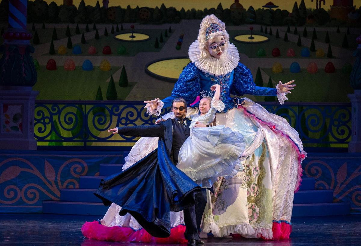 Kansas City Ballet’s Gavin Abercrombie, as Dr. Drosselmeier, and Samantha Stortzum, as Clara, dance with Mother Ginger in the final dress rehearsal of “The Nutcracker.” Mother Ginger, a puppet, stands 10-feet tall and is powered both manually and electronically.