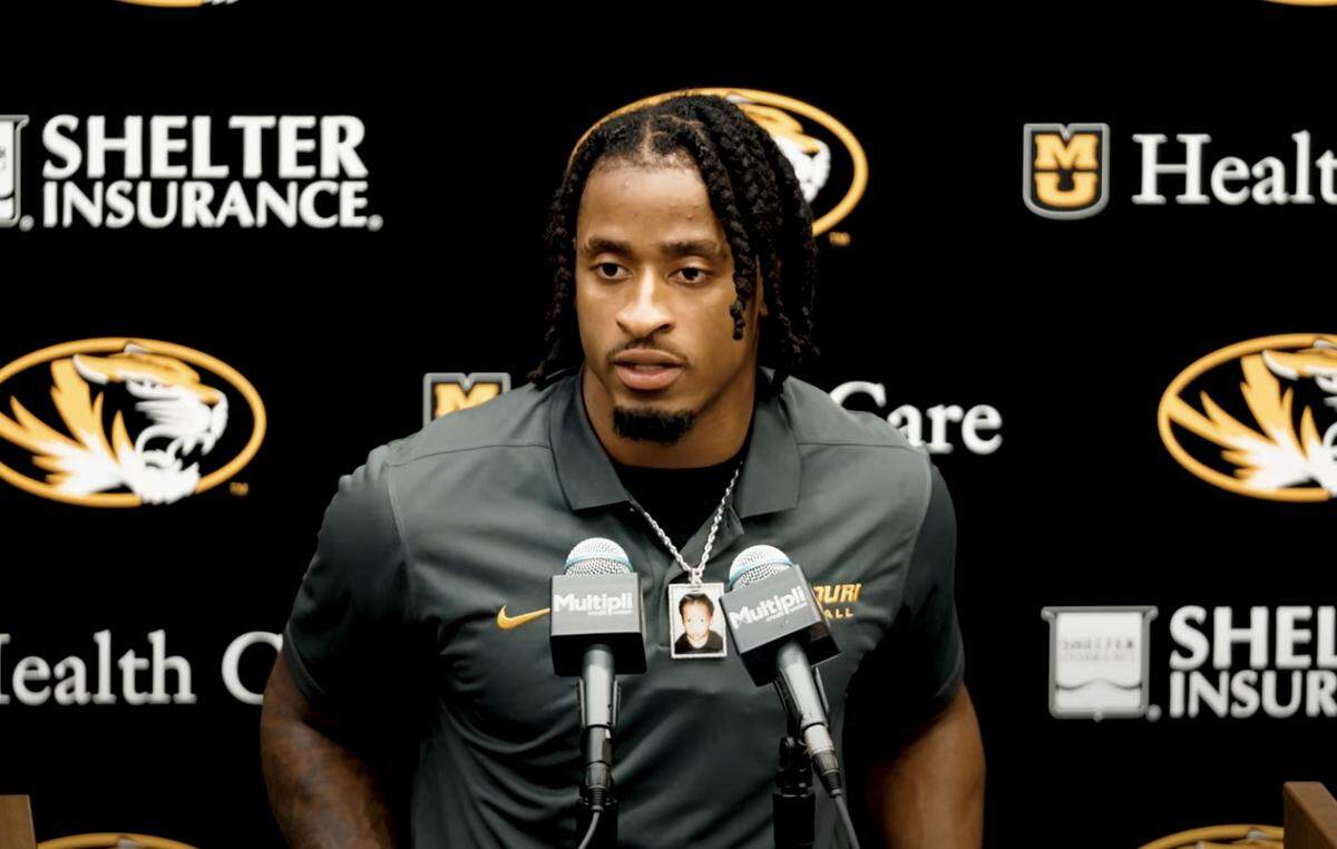 Missouri Tigers football player Kevin Coleman Jr. wears a small, framed photo of his late baby brother, Rashaad, on a necklance.