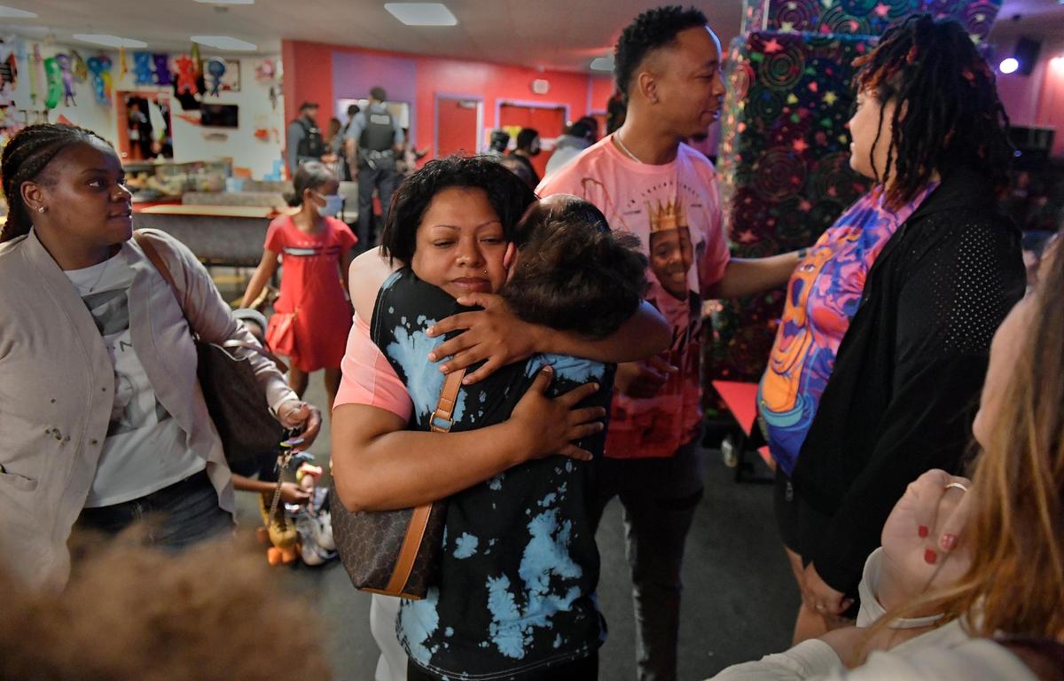 During a fundraiser held Thursday evening, Vincenta Guzman, the mother of the late Manny Guzman, receives a hug from Amber Burgard, as family and friends gathered to honor the Kansas City teen who was fatally stabbed in a bathroom at Northeast Middle School. Guzman loved to roller skate and dozens of patrons who knew him gathered at the rink to remember him and raise money for his funeral expenses.