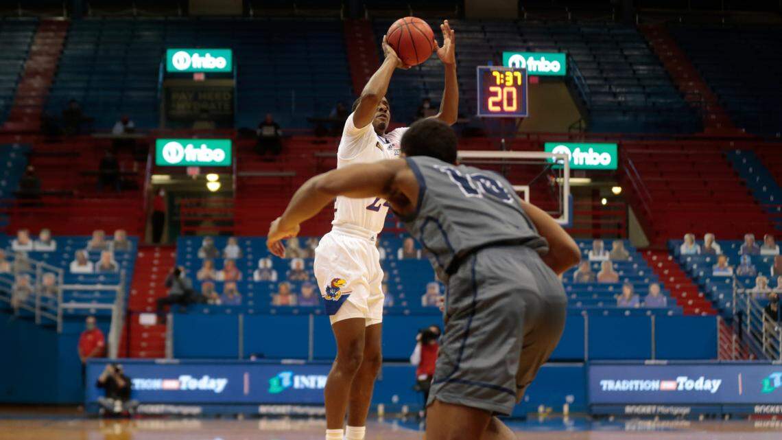 Kansas freshman guard Bryce Thompson goes up for a 3-point shot against Washburn during an NCAA college basketball game Thursday, Dec. 3, 2020, in Lawrence, Kan. Cardboard cutouts of fans are in the seats at rear. (Evert Nelson/The Topeka Capital-Journal via AP)