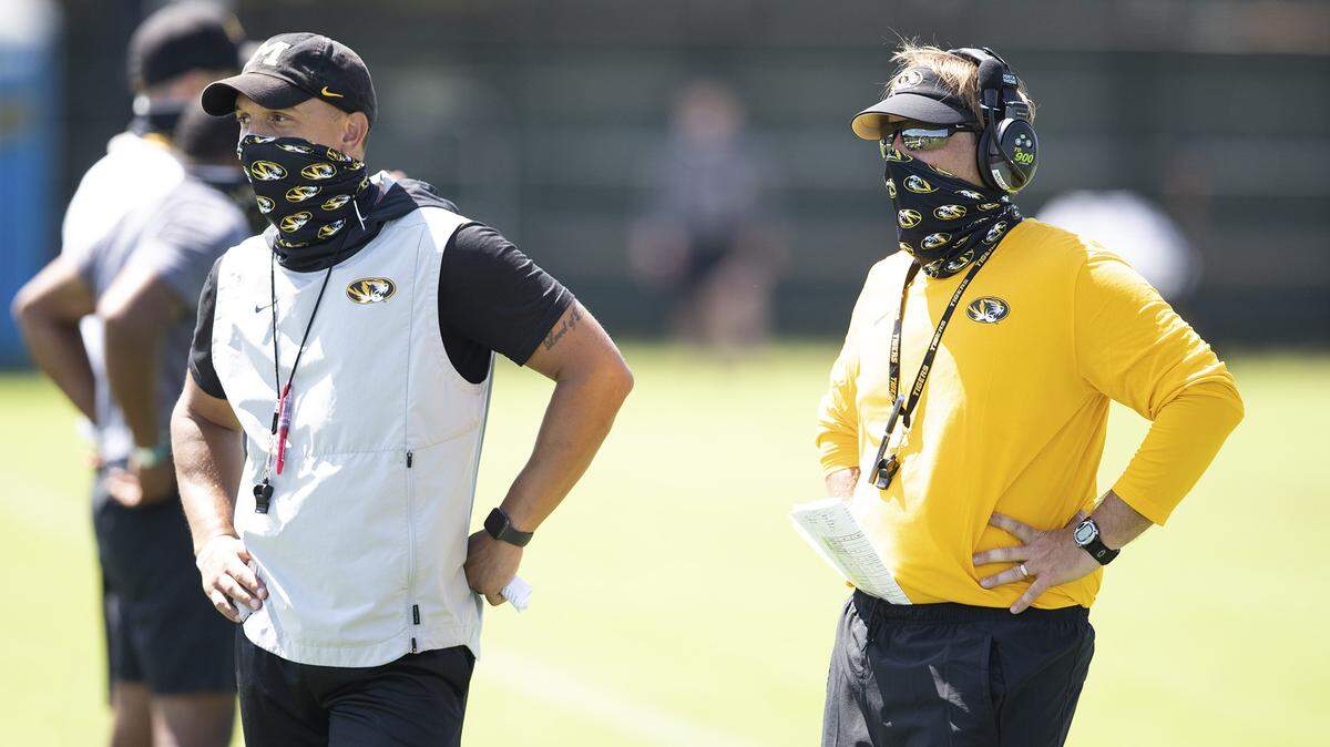 Mizzou defensive coordinator Ryan Walters (left) and head coach Eli Drinkwitz observe the Tigers during the opening day of camp in Columbia.
