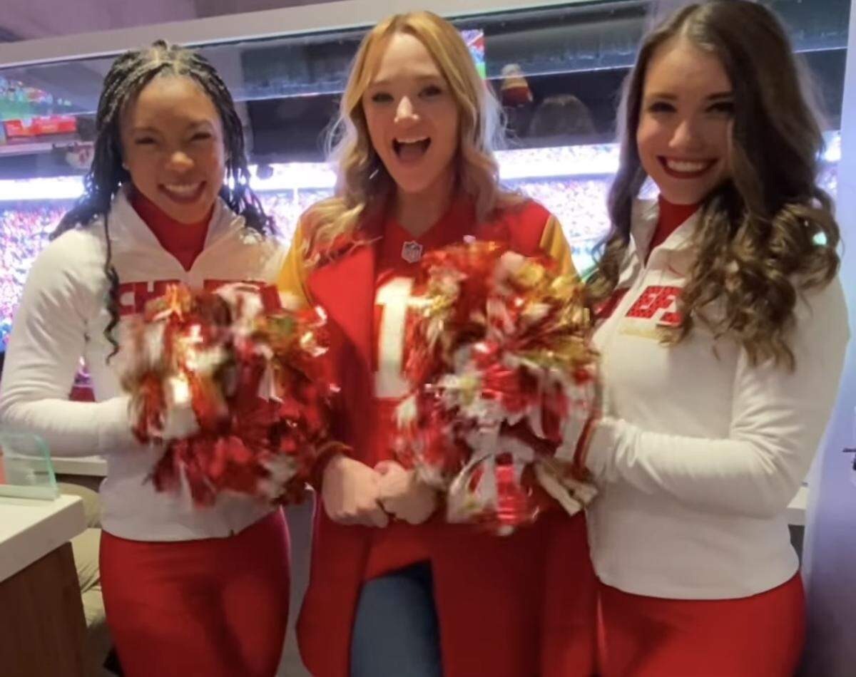 Hunter King, middle, star of “Holiday Touchdown: A Chiefs Love Story,” with Chiefs cheerleaders at Arrowhead Friday.